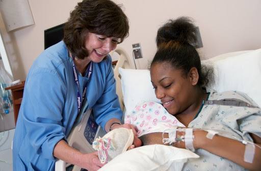 holding a baby after giving birth