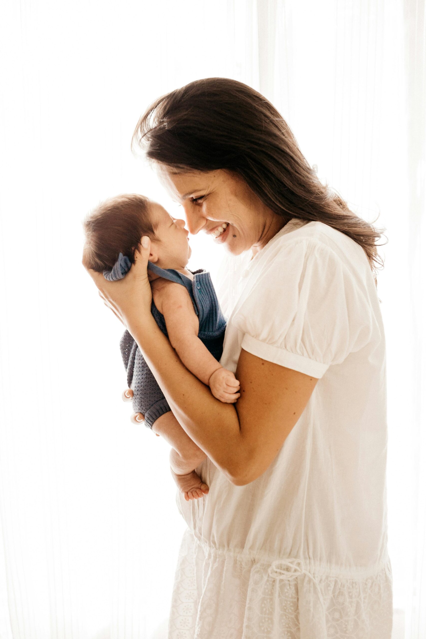 Happy, smiling mother holding her baby